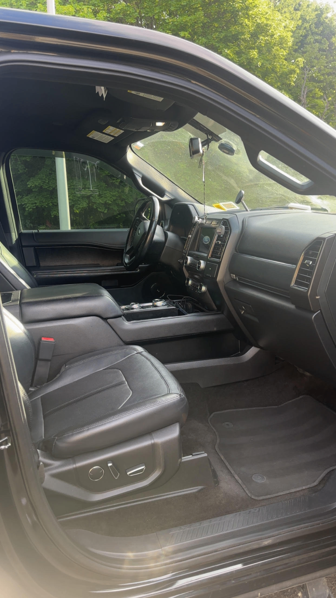 Professional car detailing with a shiny black sedan being hand-washed and polished