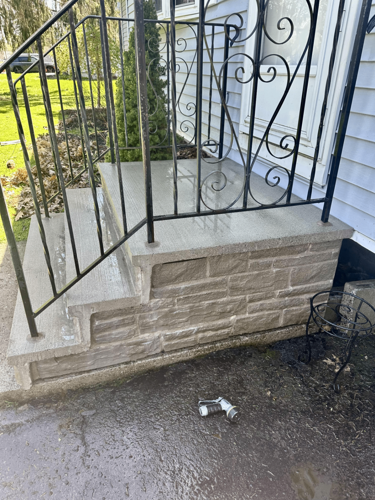 Pressure washer cleaning a concrete driveway